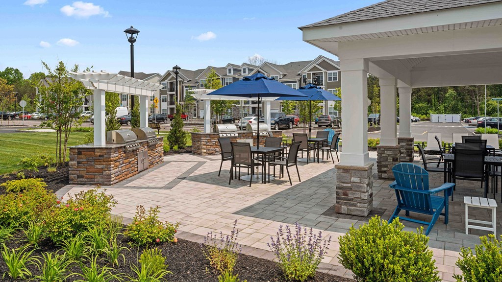 a patio with tables and chairs and umbrellas