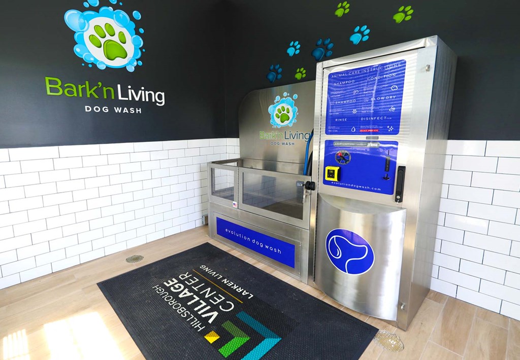 a refrigerator in a store with a black rug on the floor