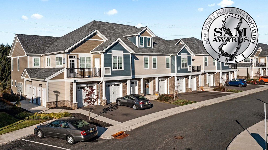 a row of houses with cars parked in front of them