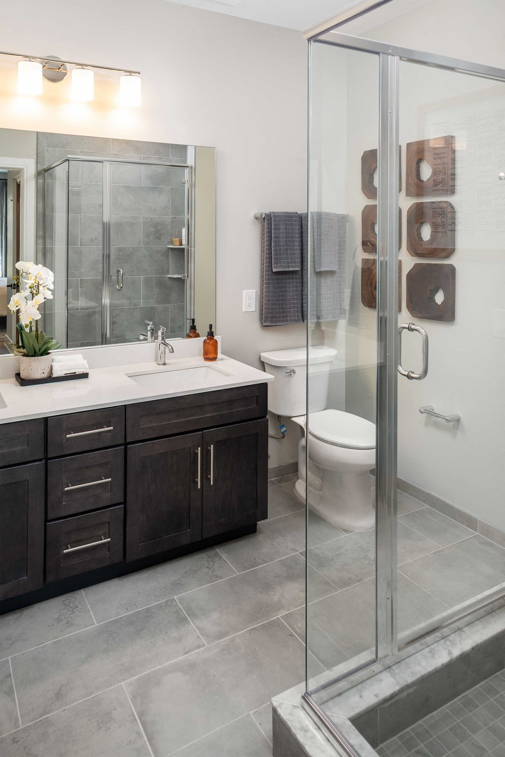 a bathroom with a shower and a sink and a toilet