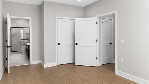 A white door is open to a bathroom.