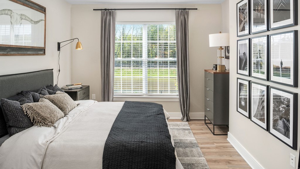 a bedroom with a large bed and a window