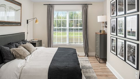 a bedroom with a large bed and a window