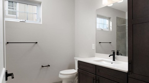 A white toilet sits next to a sink in a bathroom.