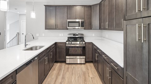 a kitchen with wooden cabinets and stainless steel appliances