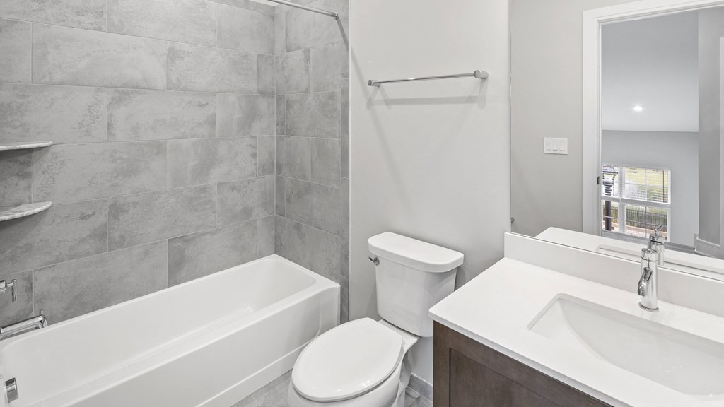 a bathroom with a sink toilet and a bath tub