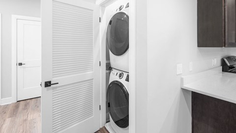 a washer and dryer in a white laundry room with a door