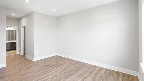 a living room with wood floors and white walls