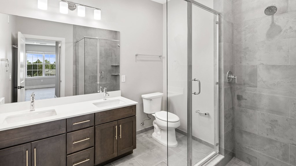 a bathroom with a shower and a sink and a toilet
