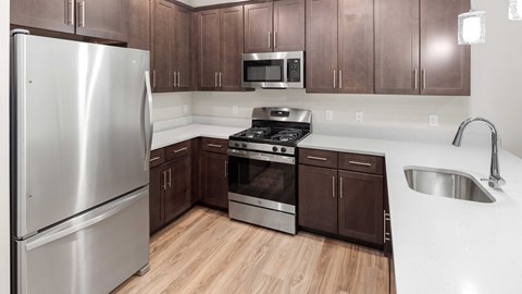 a kitchen with stainless steel appliances and wooden cabinets