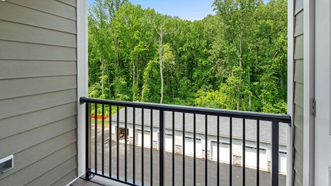 a balcony with a view of a forest