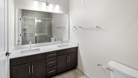 the preserve at ballantyne commons community bathroom with two sinks and a large mirror