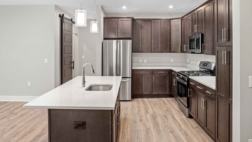 a kitchen with wooden cabinets and stainless steel appliances