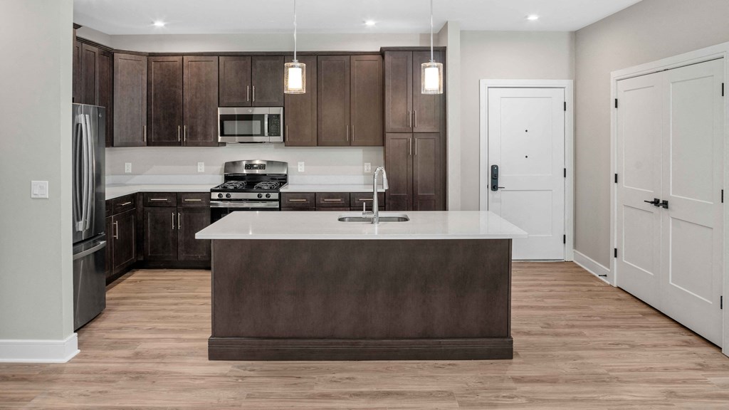 a kitchen with wooden cabinets and a white counter top