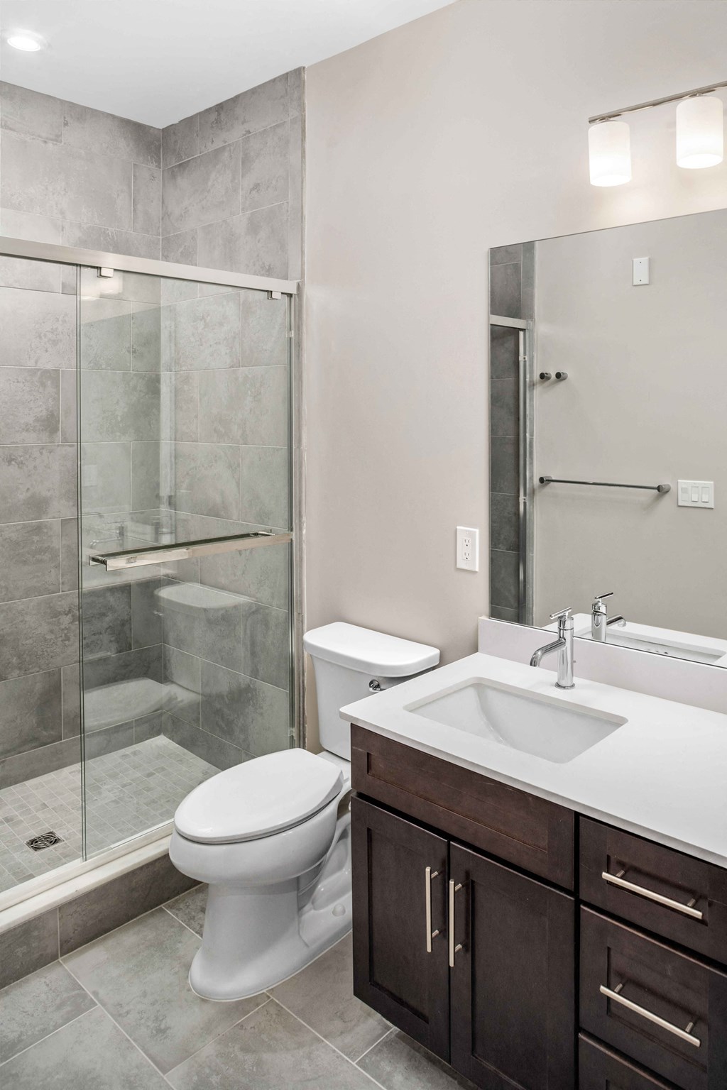 a bathroom with a toilet and a sink and a shower