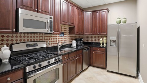 A kitchen with brown cabinets and a black stove top.