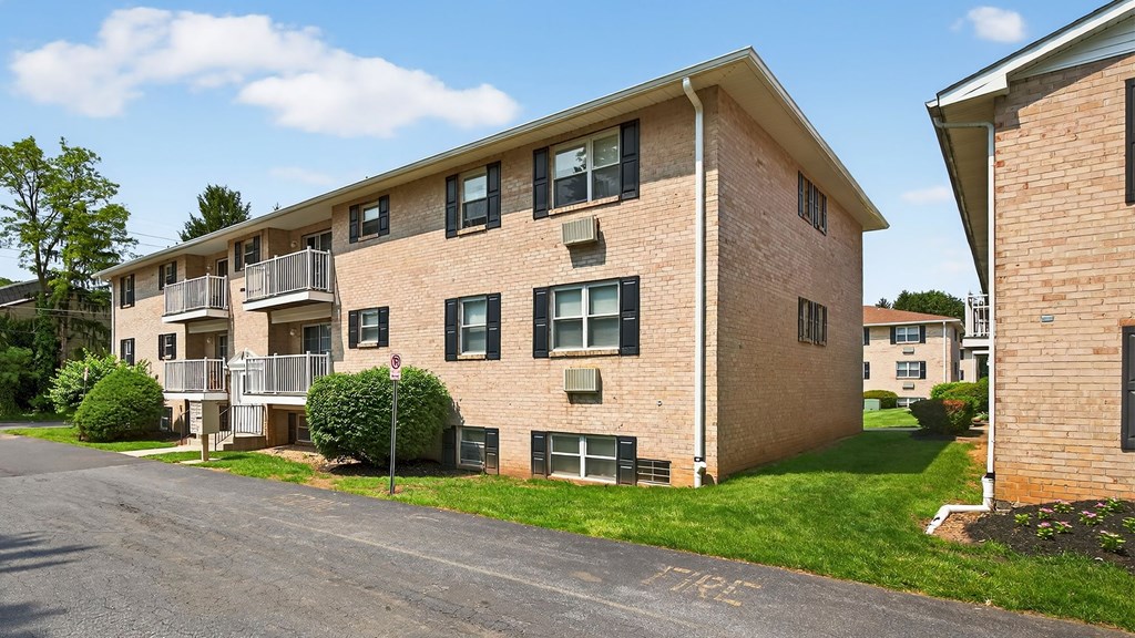 Apartment building with a sign that says "No Parking" painted on the street.