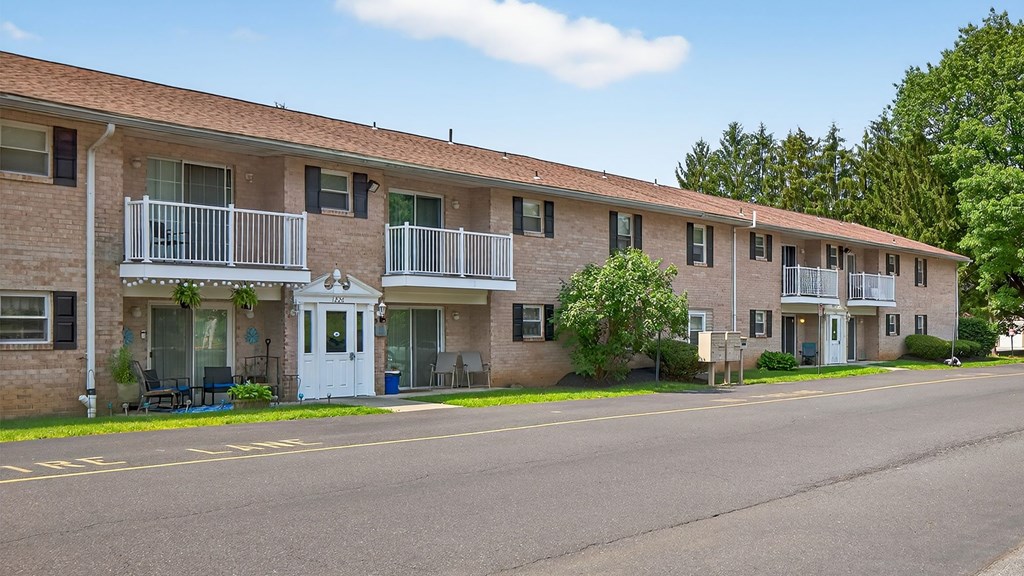 Apartment building with a white door and balcony.