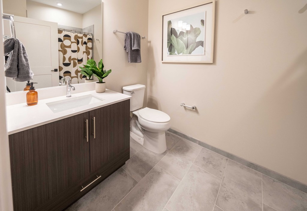 a bathroom with a toilet and a sink and a mirror