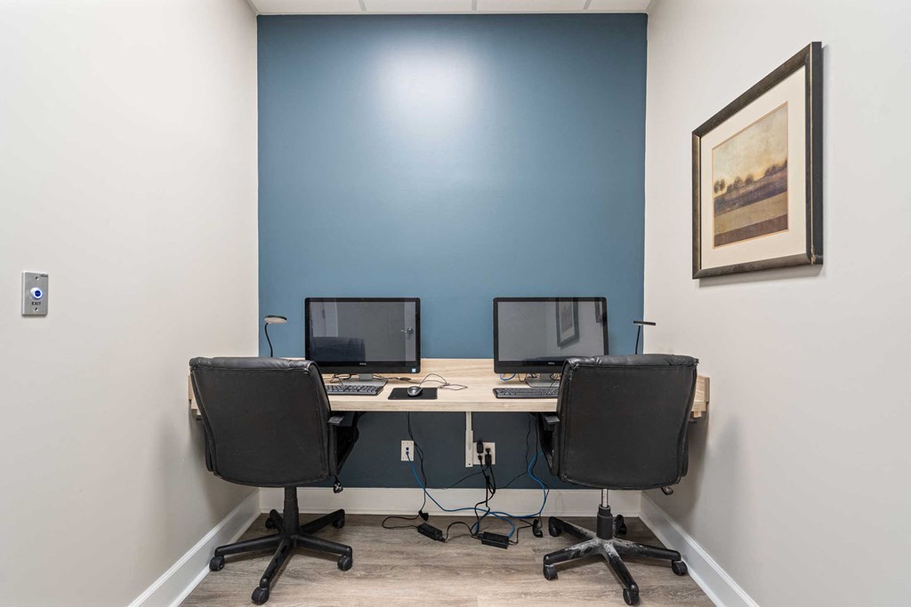 a home office with two computers on a desk