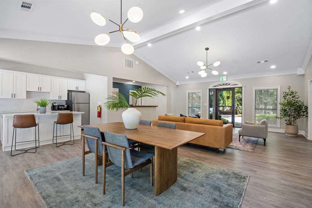 a living room and dining room with a table and chairs