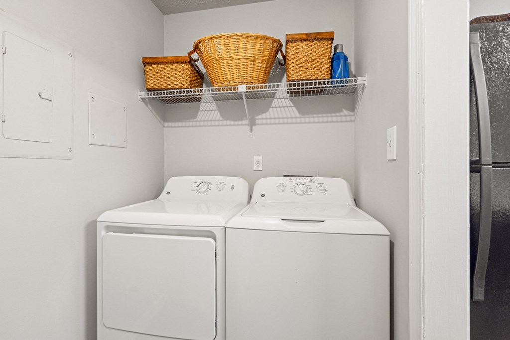 the laundry room has a washer and dryer and a refrigerator