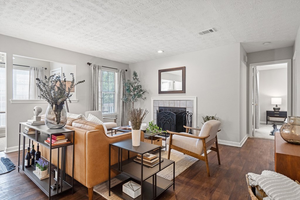 a living room with a couch and chairs and a fireplace