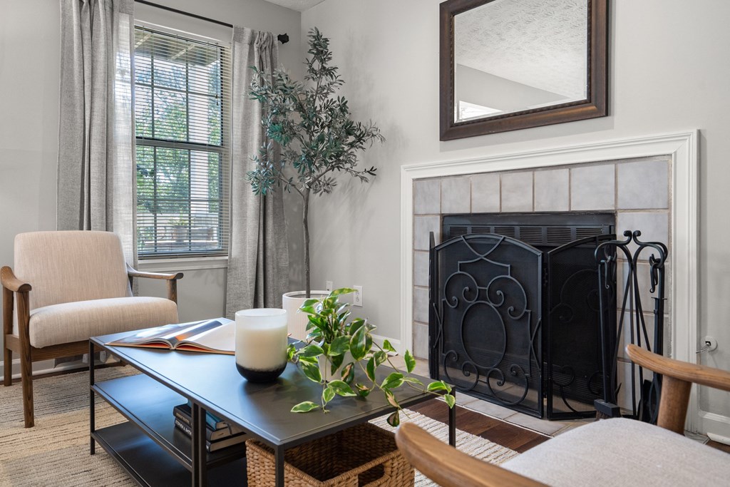 a living room with a fireplace and a table with chairs