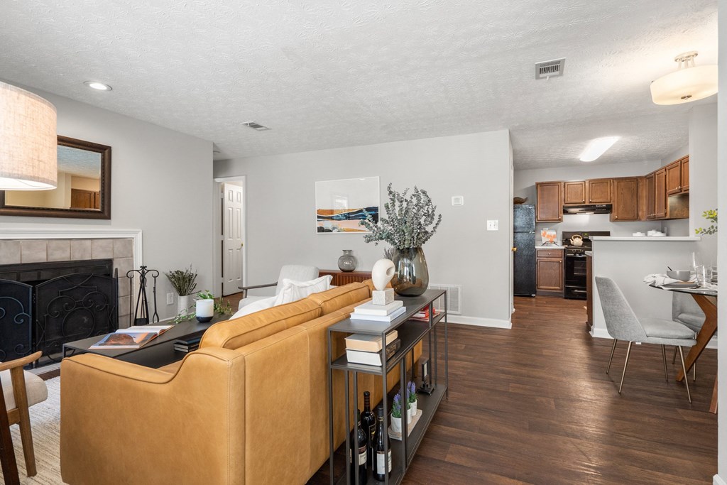 the view of a living room and dining room with a fireplace