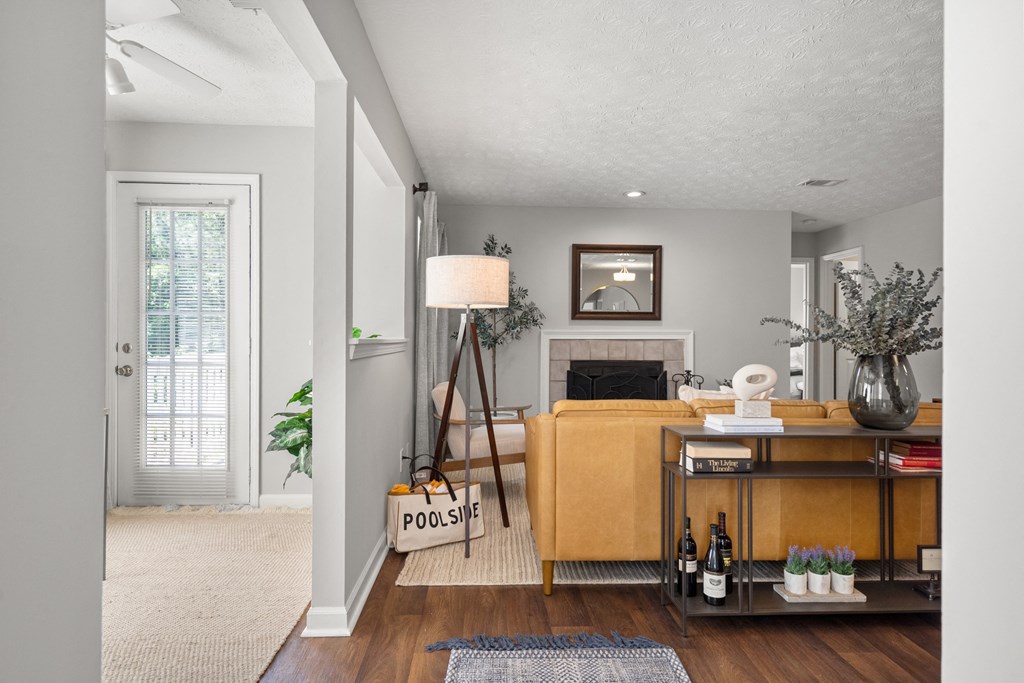 a living room with a couch and a desk and a fireplace