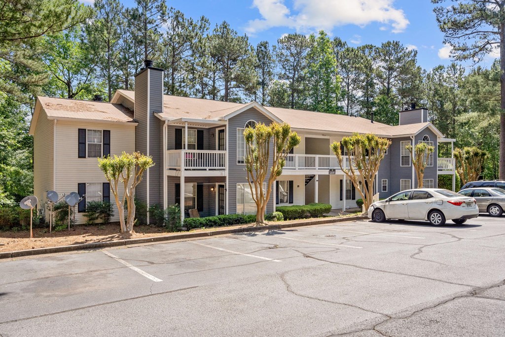 an empty parking lot in front of an apartment building