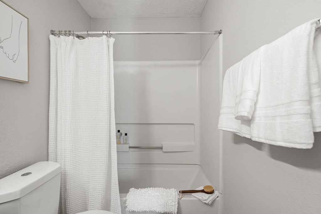 a small bathroom with a shower and a toilet