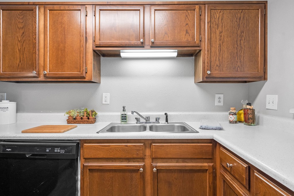 a kitchen with wooden cabinets and a sink