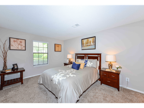a bedroom with a bed and two night stands