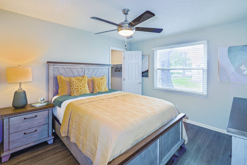 a bedroom with a bed and a ceiling fan
