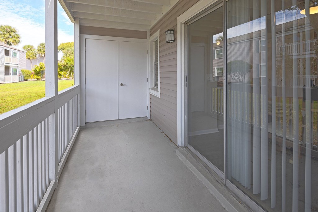the front porch of a home with glass doors and a patio