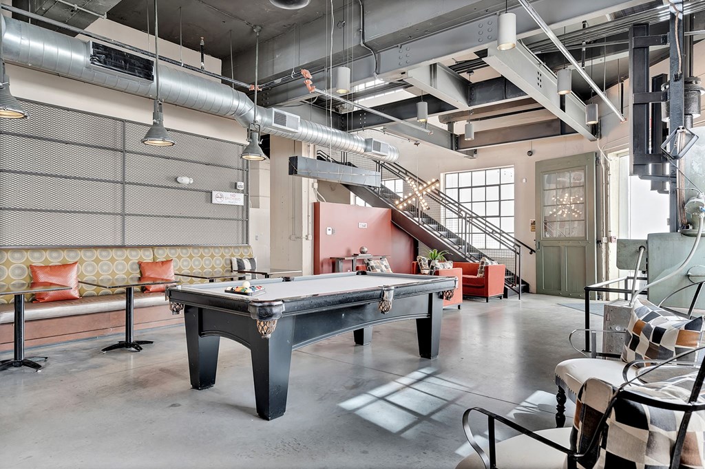 a pool table in an open room in a loft
