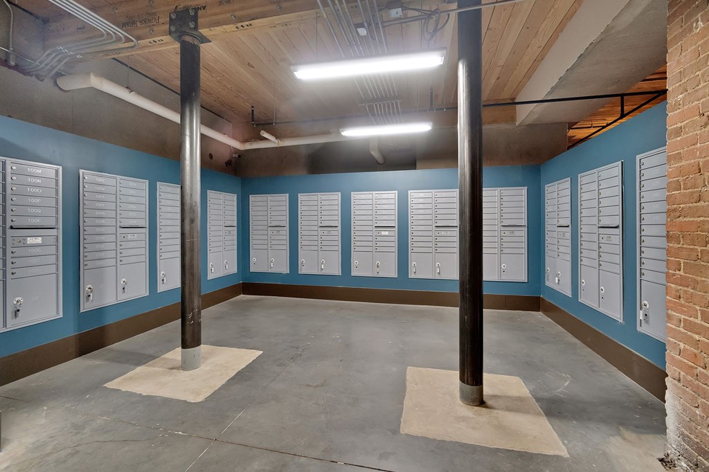 the locker room at the gym has a row of lockers on the wall