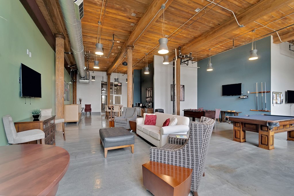 a large living room with furniture and a pool table