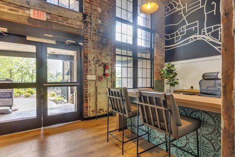 a dining room with a table and chairs in front of a window