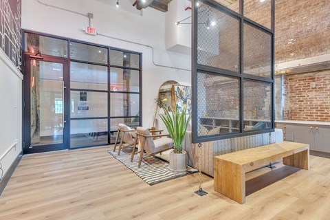 the lobby of a building with a bench and a glass door