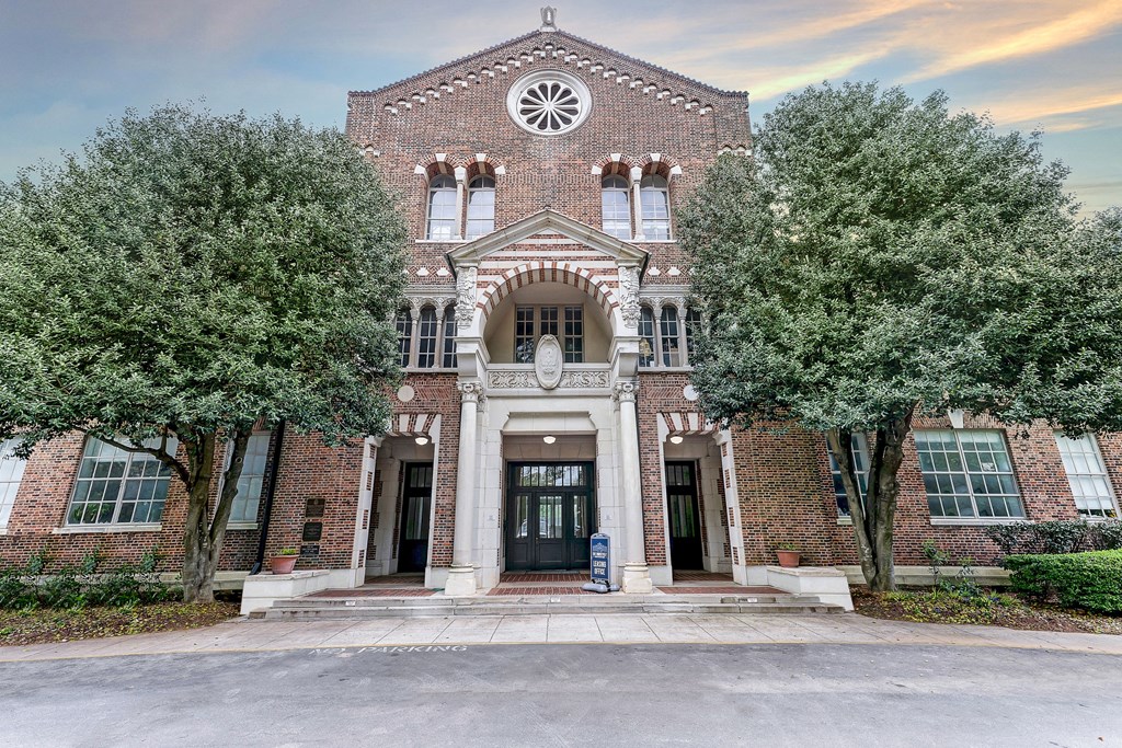 a large brick building with trees in front of it