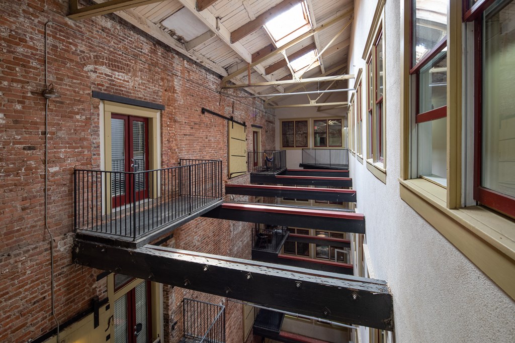 the interior of a building with a staircase and brick walls