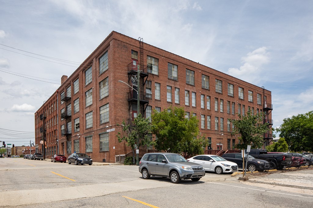 a large brick building with cars parked in front of it