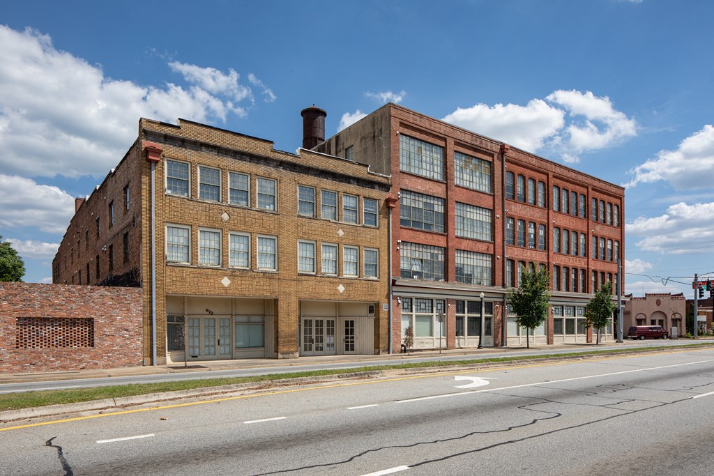 an old brick building on the side of a street