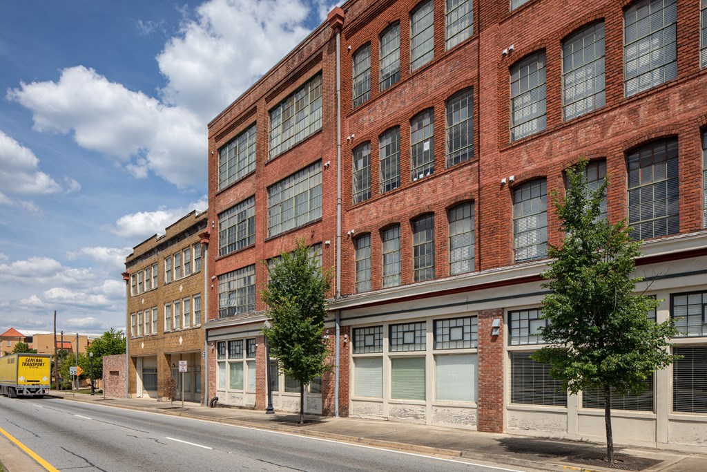 a large red brick building on a city street