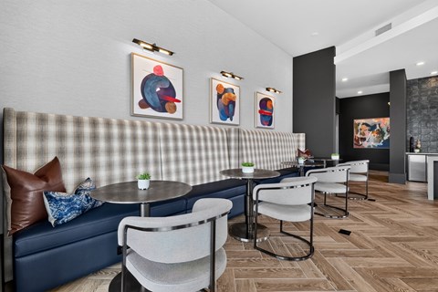 A modern dining area with a checkered booth and chairs.