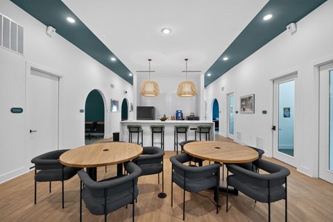 A modern dining room with a round table and chairs.