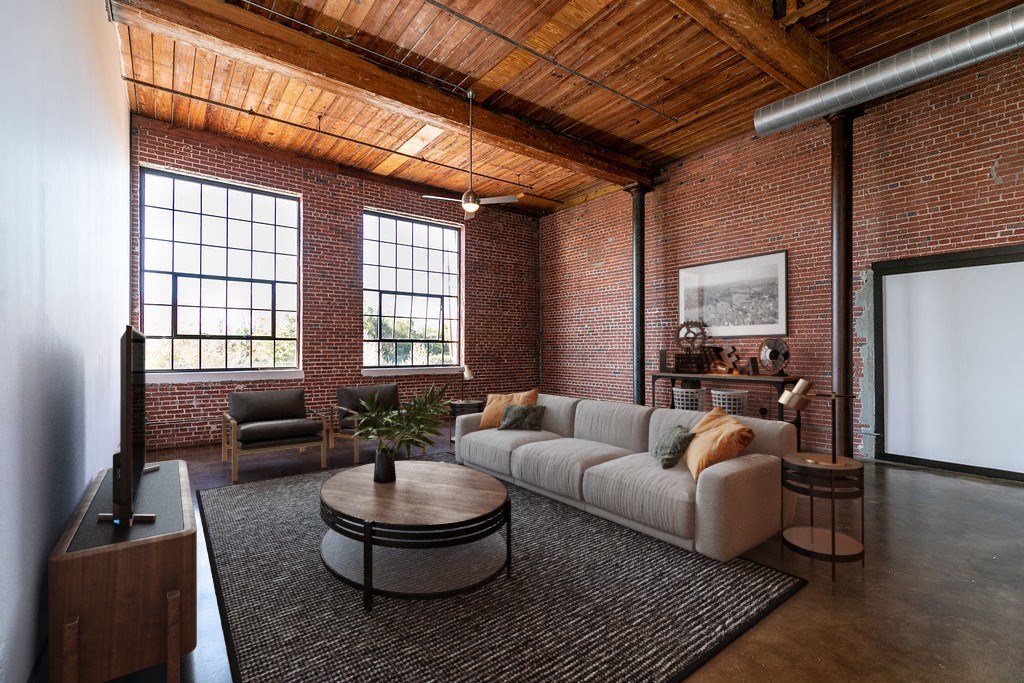 a living room with a couch and a table in a loft