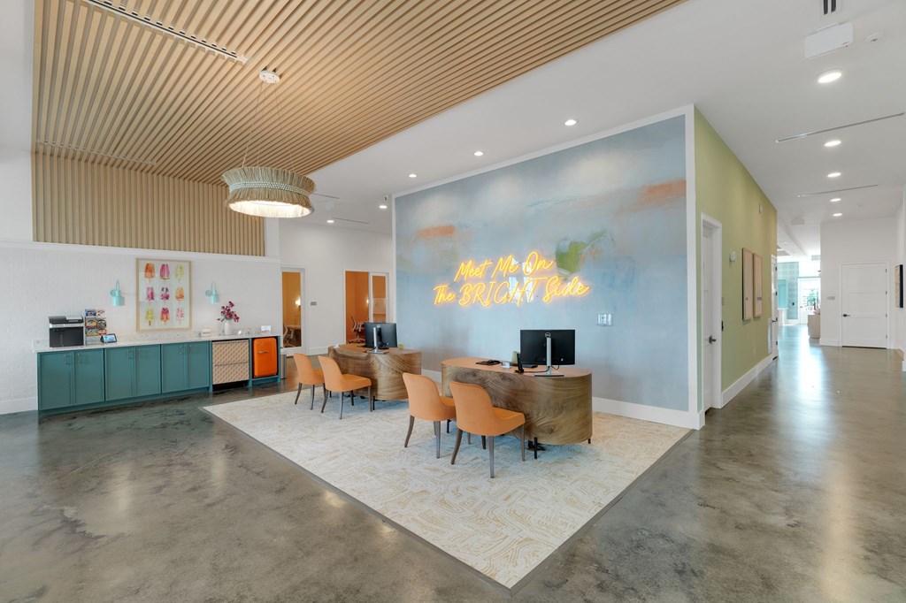 a conference room with a blue wall and a desk and chairs